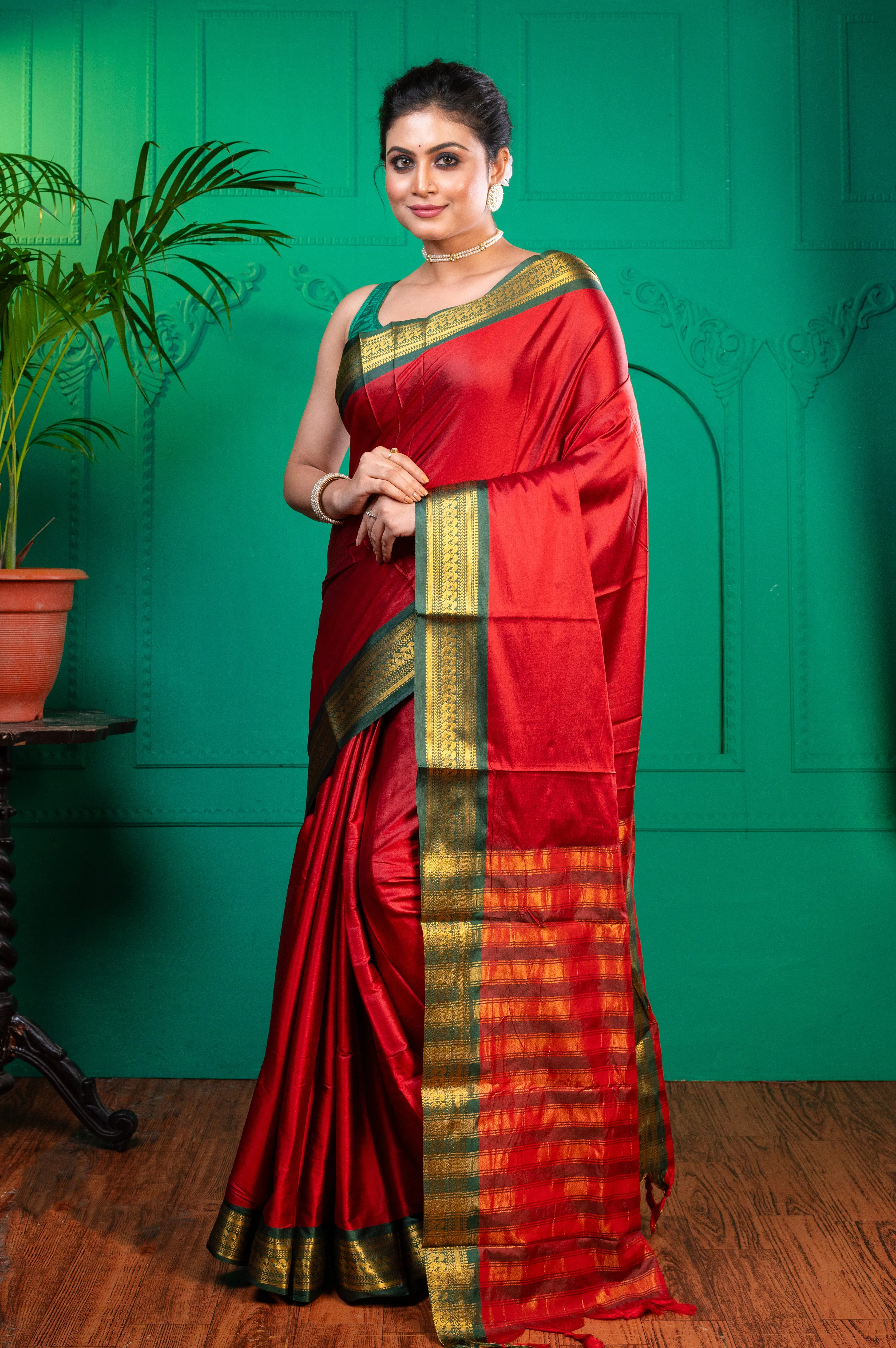 Women Red Aura Silk Saree With Contrasting Green And Golden Zari Border