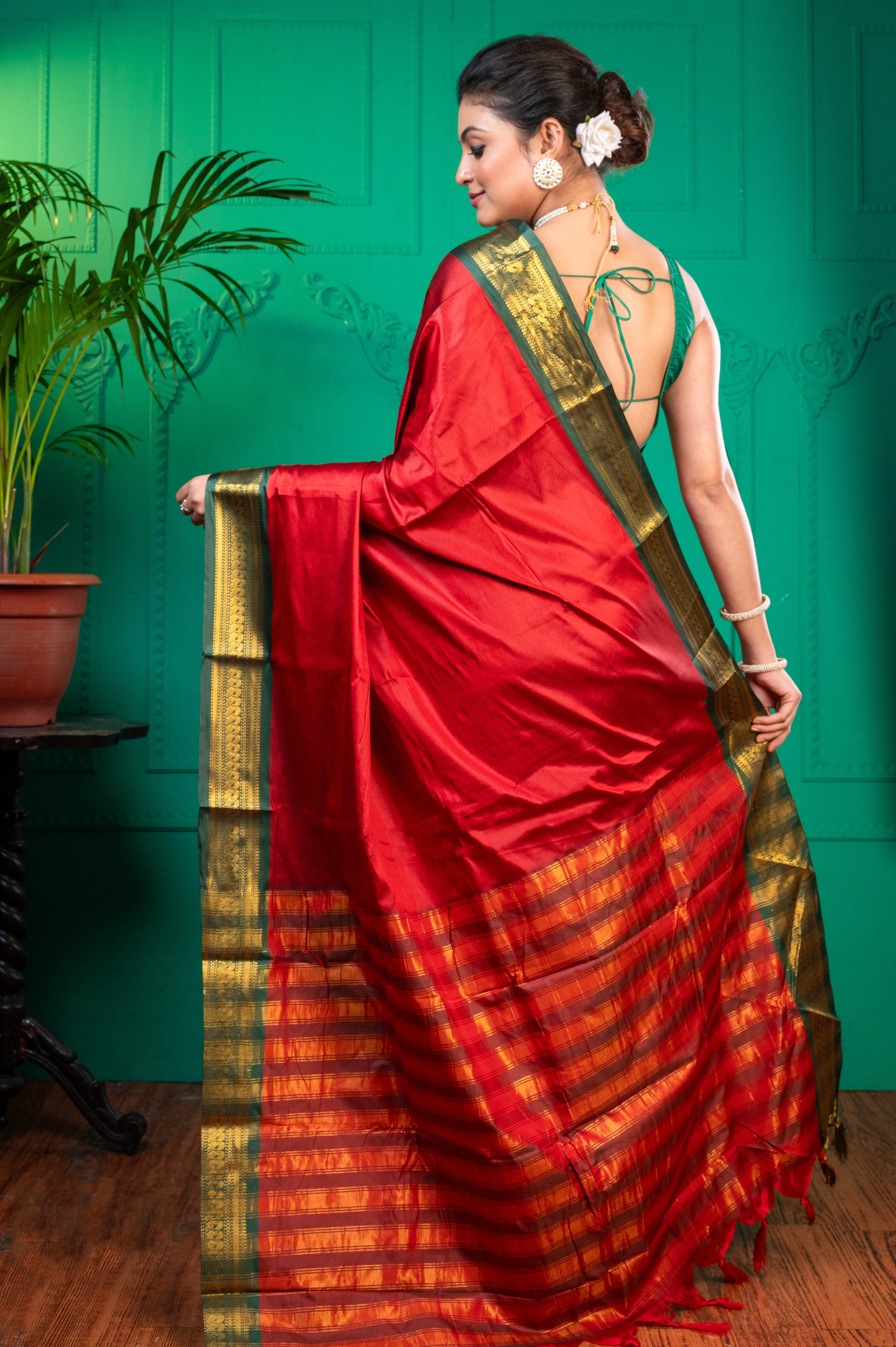 Women Red Aura Silk Saree With Contrasting Green And Golden Zari Border